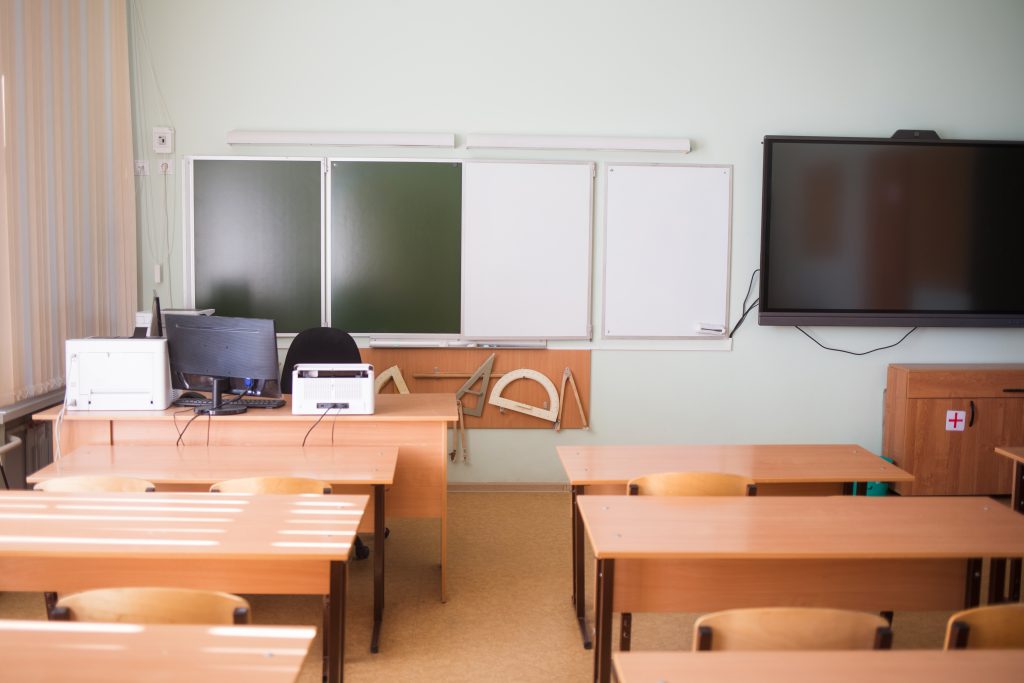 School mathematics classroom in background without young student. class room no kid or teacher with chairs and tables in campus
